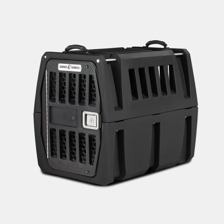 The GUNNER G1™ KENNEL - BLACK is a tough dog crate with sturdy black plastic, a metal mesh door, side ventilation slats, top carrying handles, a secure latch, and reinforced design—ideal for safe pet travel or transport.
