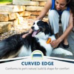 FURminator deShedding tool used gently on a dog with curved-edge feature shown